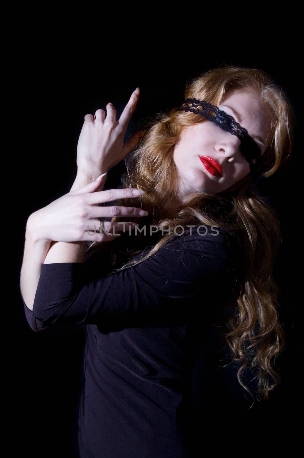 Woman with bandage on her eyes over black