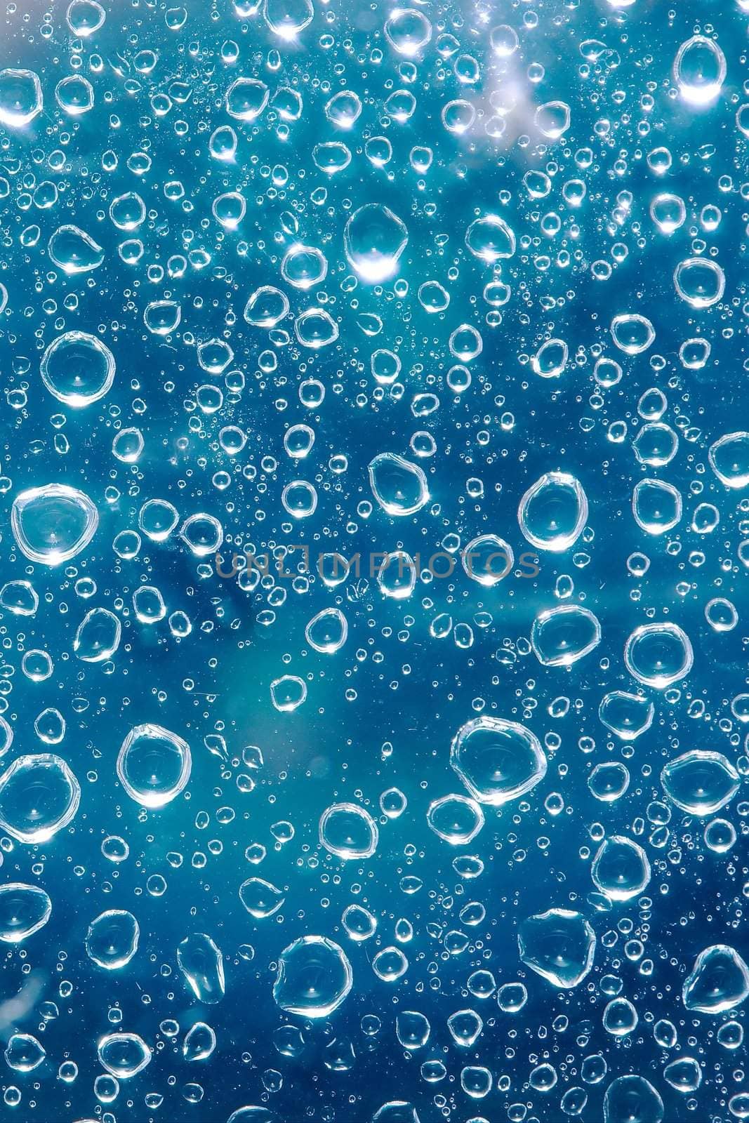 Shiny water droplets on a transparent surface