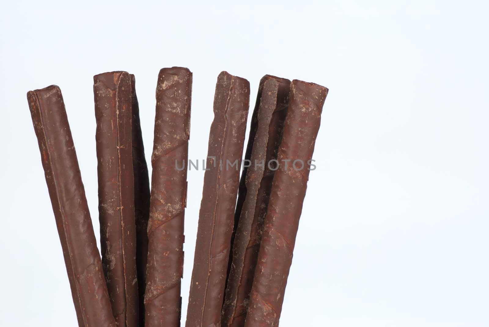 Cunchy sweet rolled chocolate wafers on white