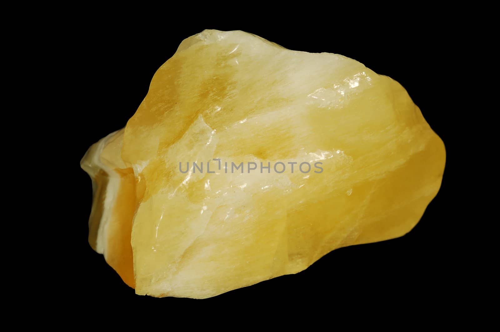 Yellow mineral calcite on black background.