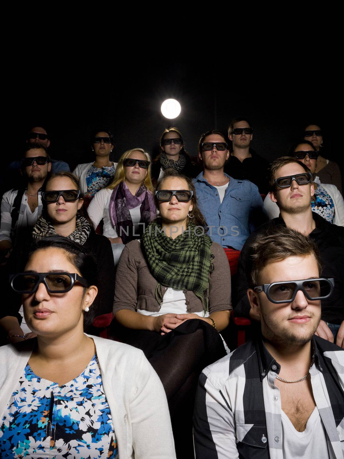 People at the movie Theater wearing 3d glasses