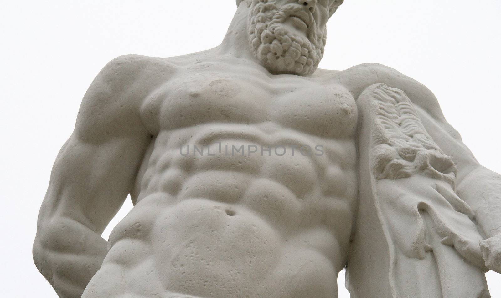 antique statue of a muscular man. Impression of strength and power stressed by the close-up