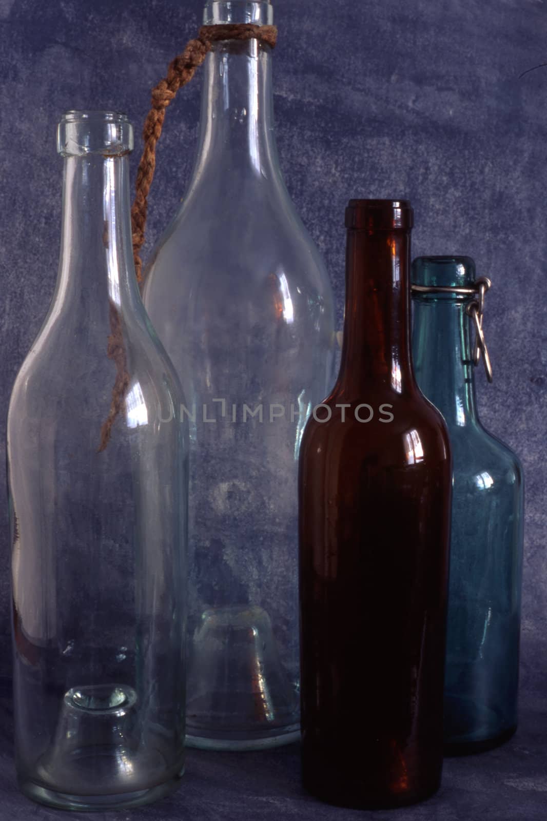 Empty bottles isolated on painted background