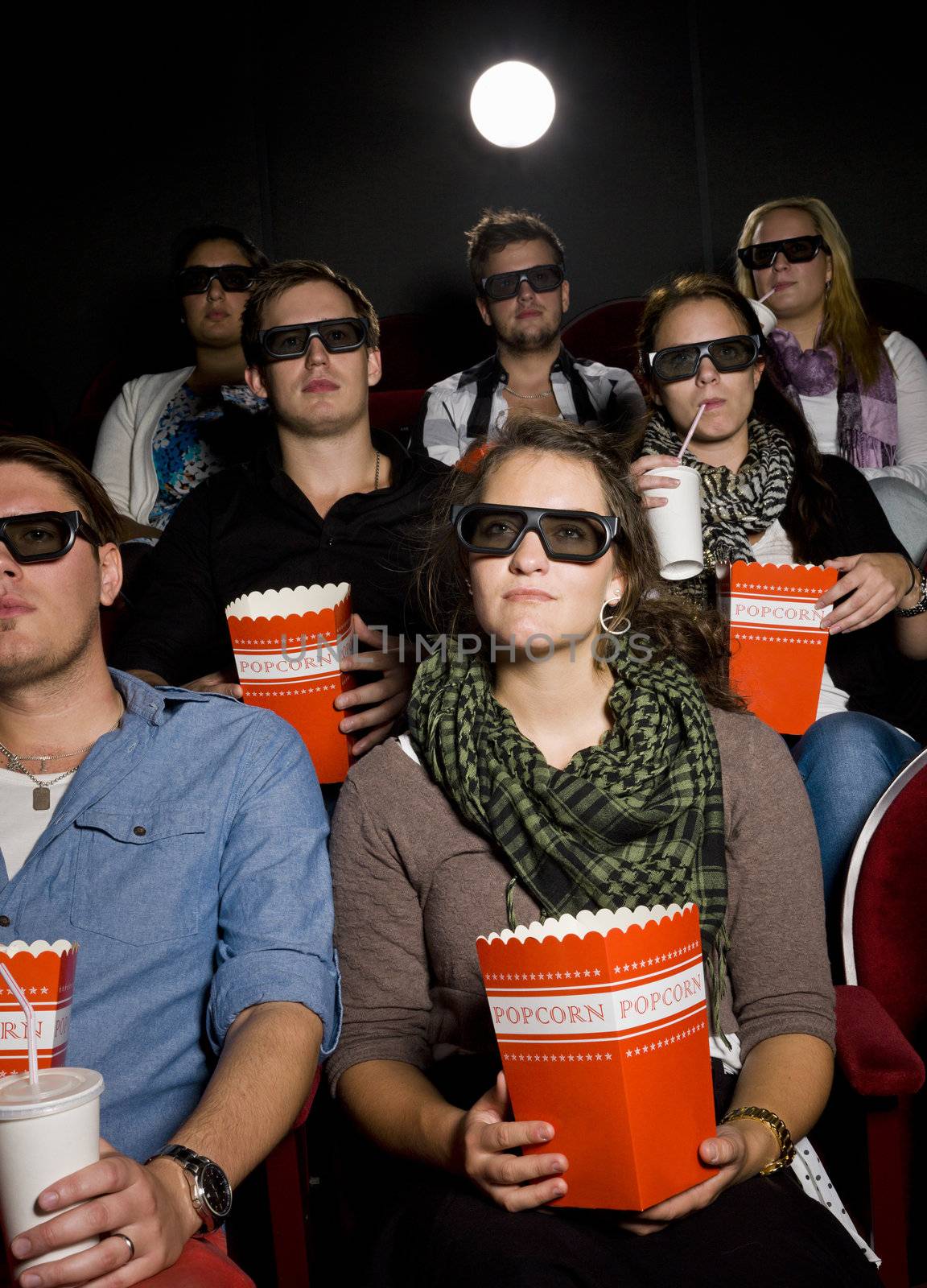 Spectators with popcorn at the movie theater