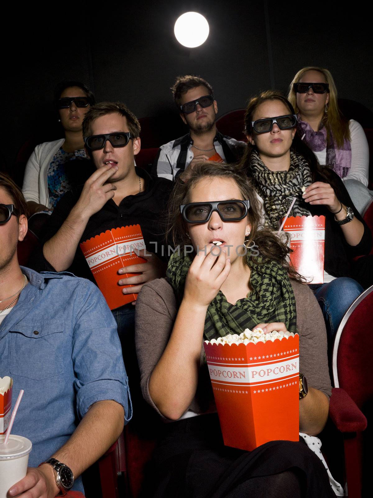 Eating popcorn at the cinema by gemenacom