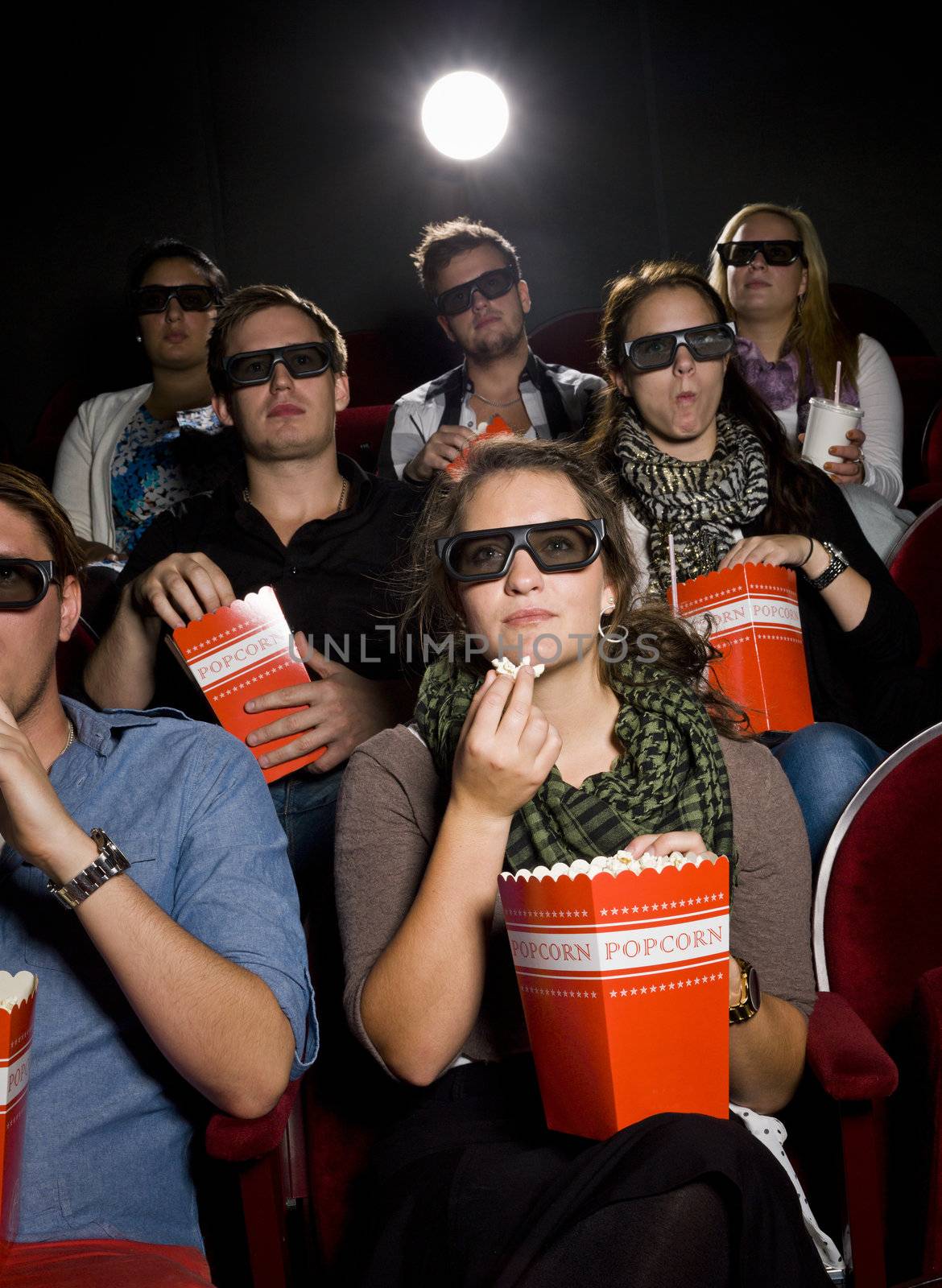 Spectators eating popcorn at the movie theater