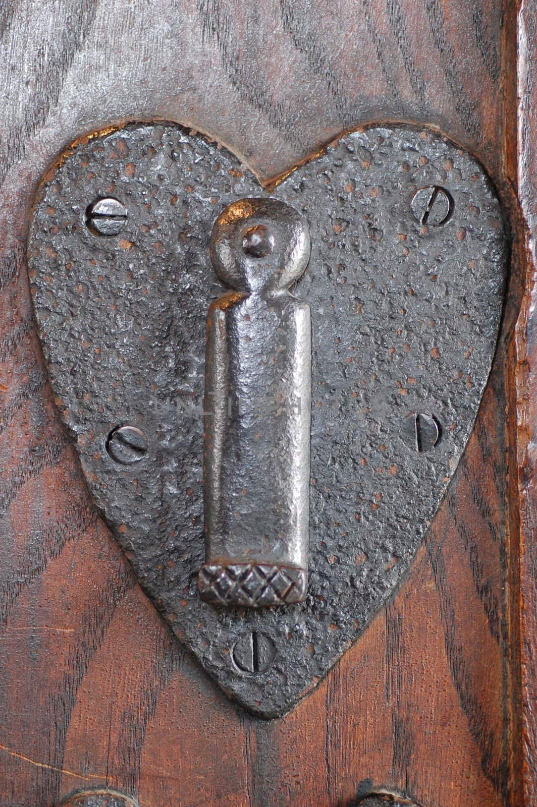 Heart shaped lock in old wooden door.