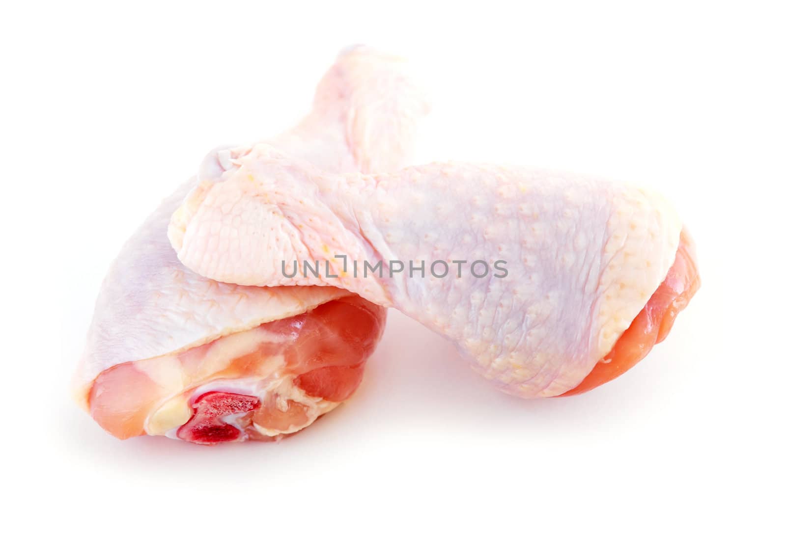 Raw chicken drumsticks isolated on white background