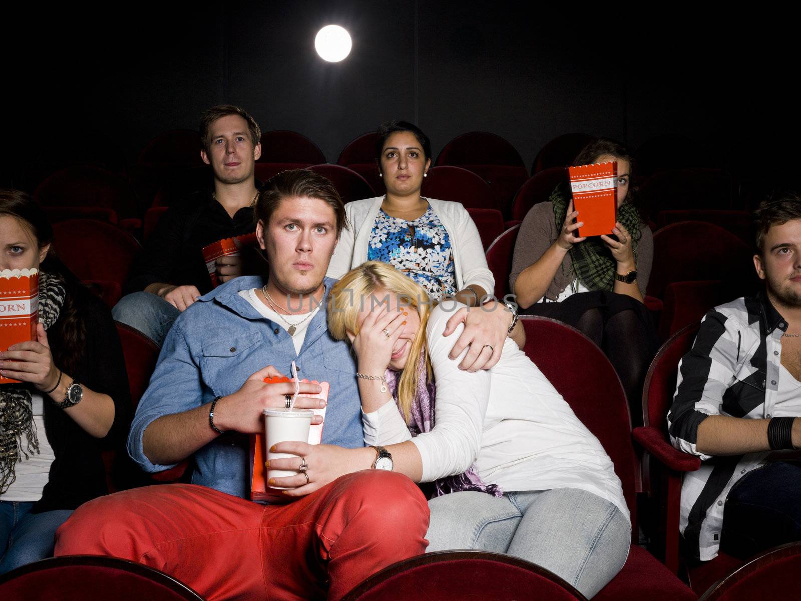 Young couple at cinema by gemenacom
