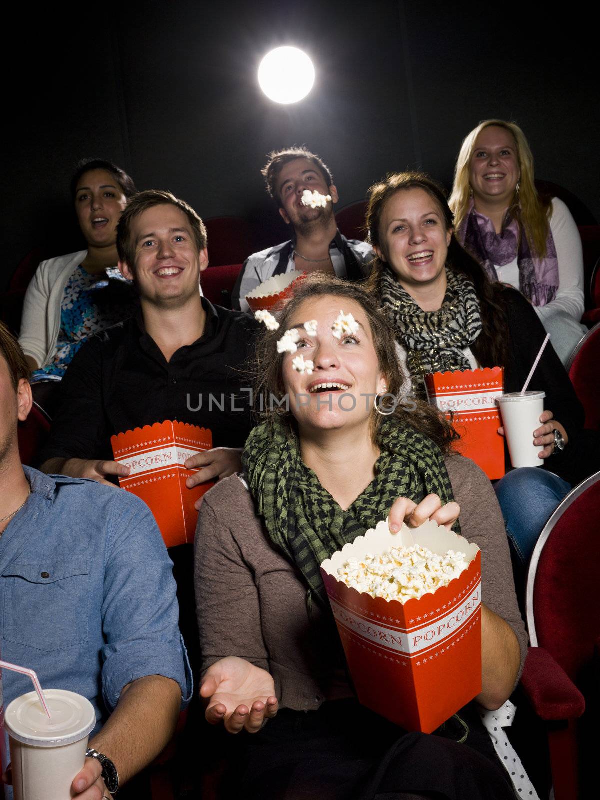 Eating popcorn at the cinema by gemenacom