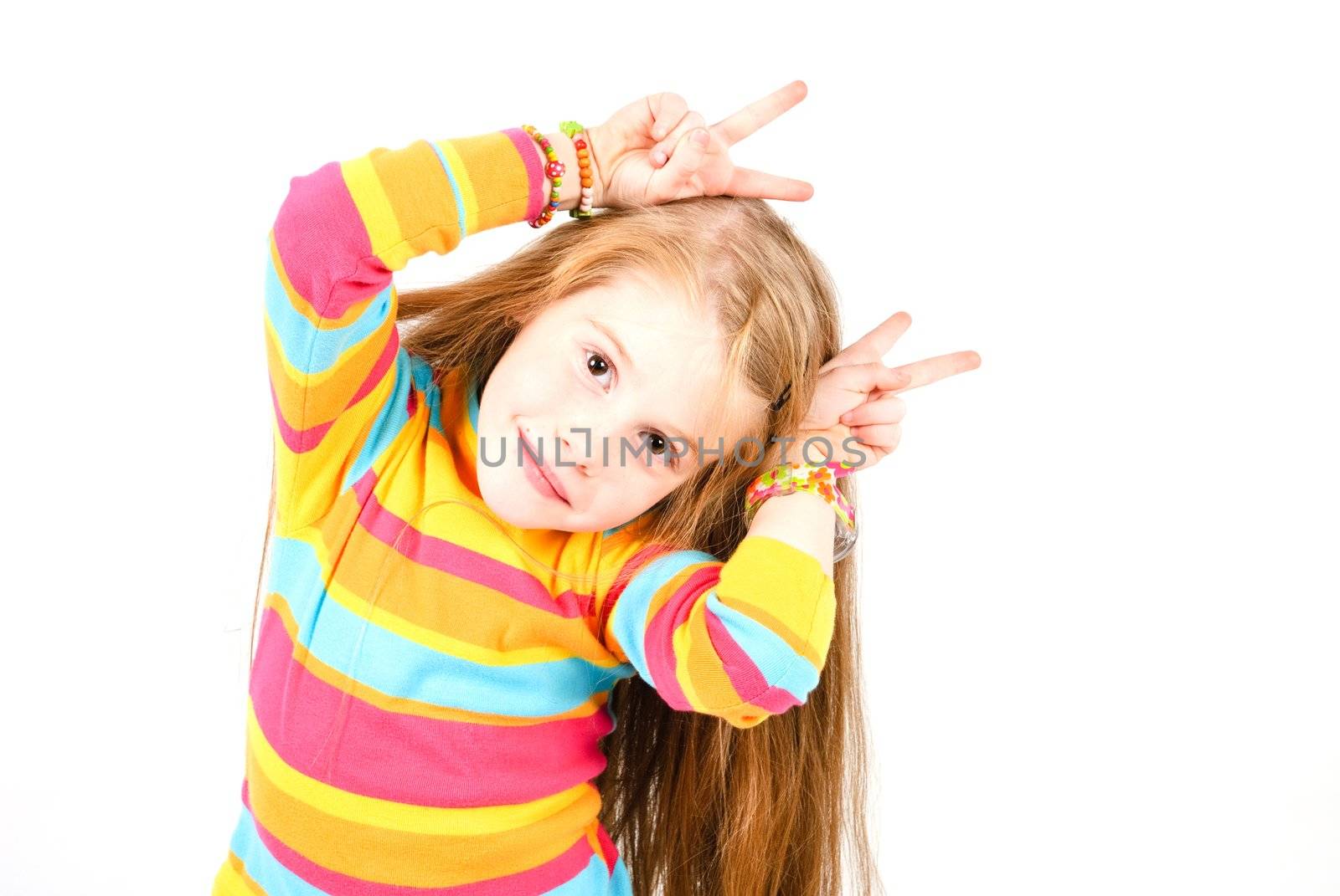 studio shot of pretty little girl with fingers like horns