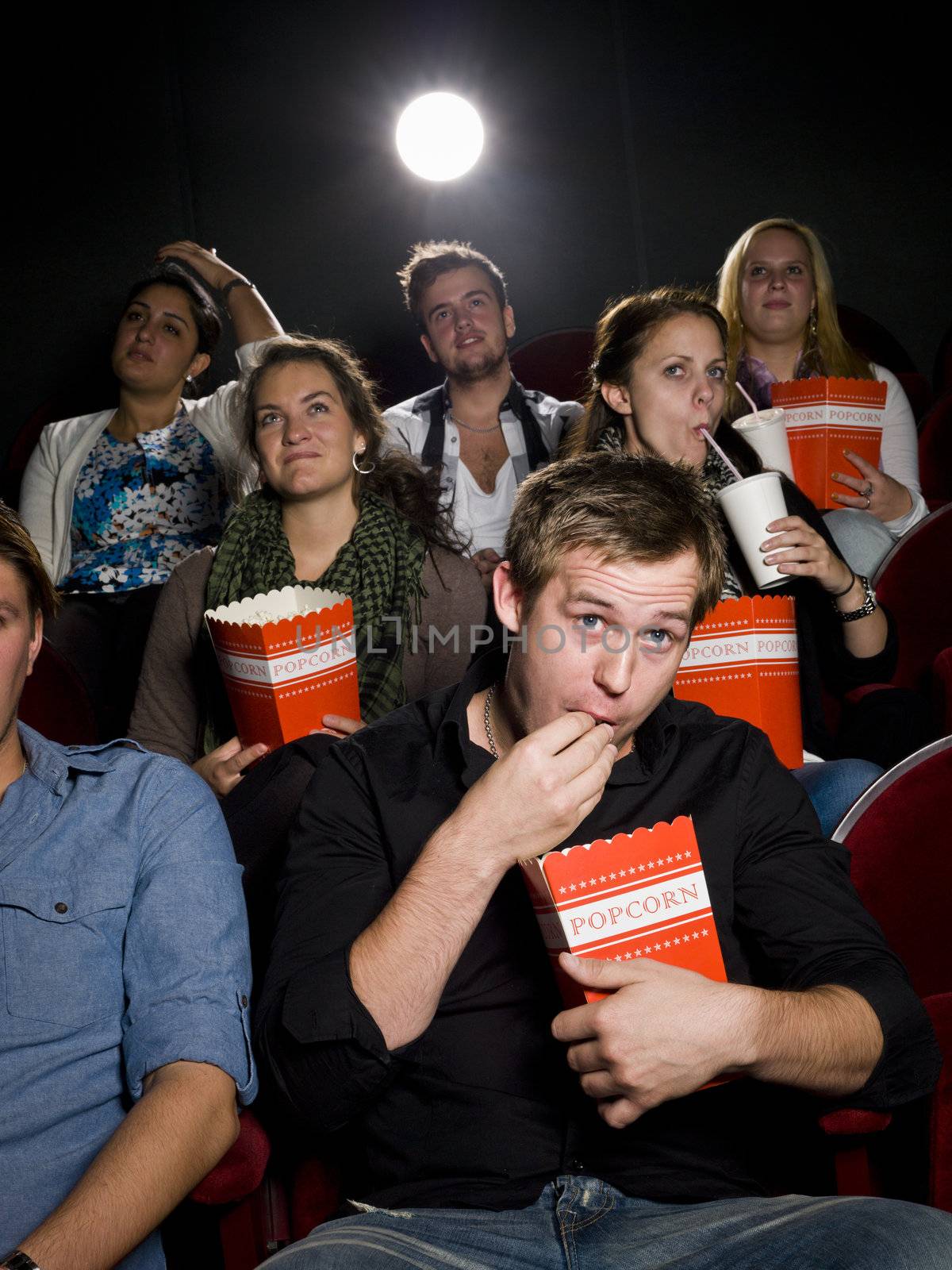 Man at the cinema with popcorn by gemenacom