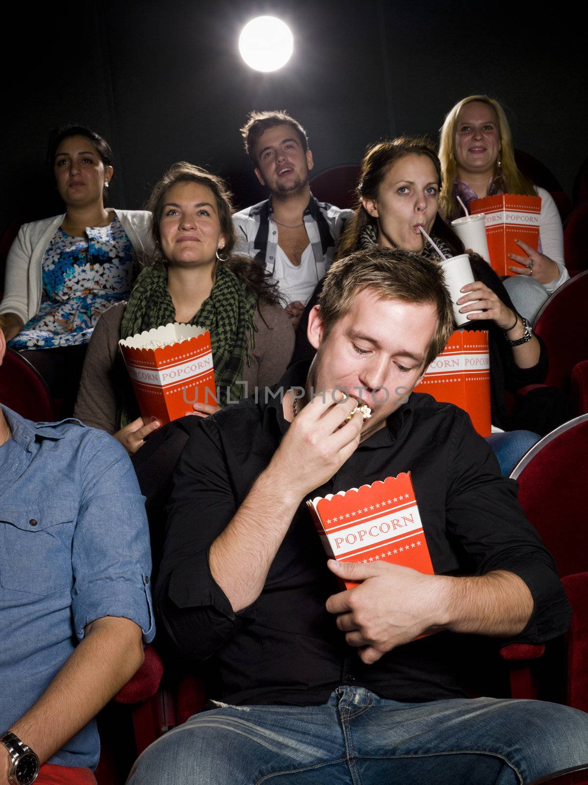 Man at the cinema with popcorn by gemenacom