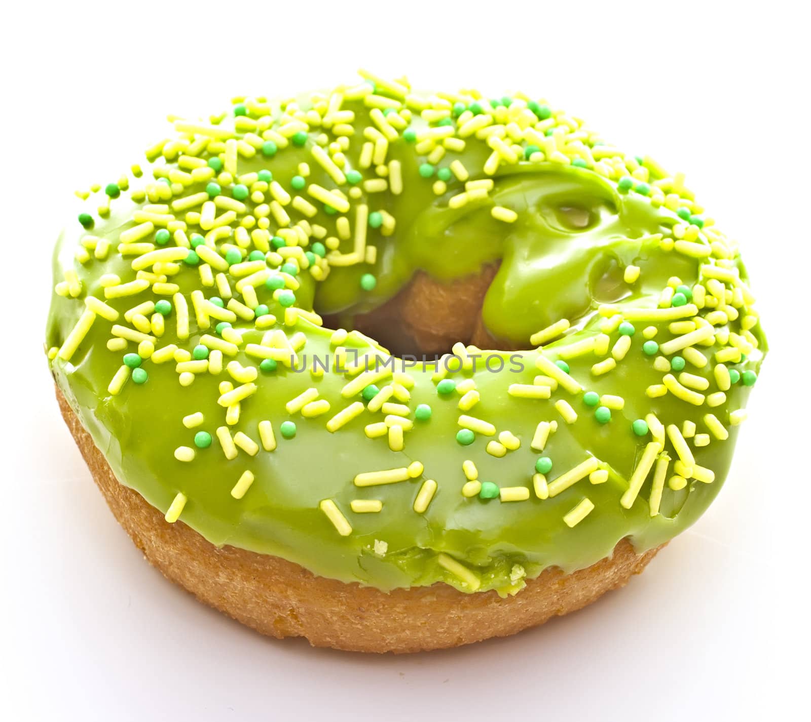 Donut on a white background with green glaze.
