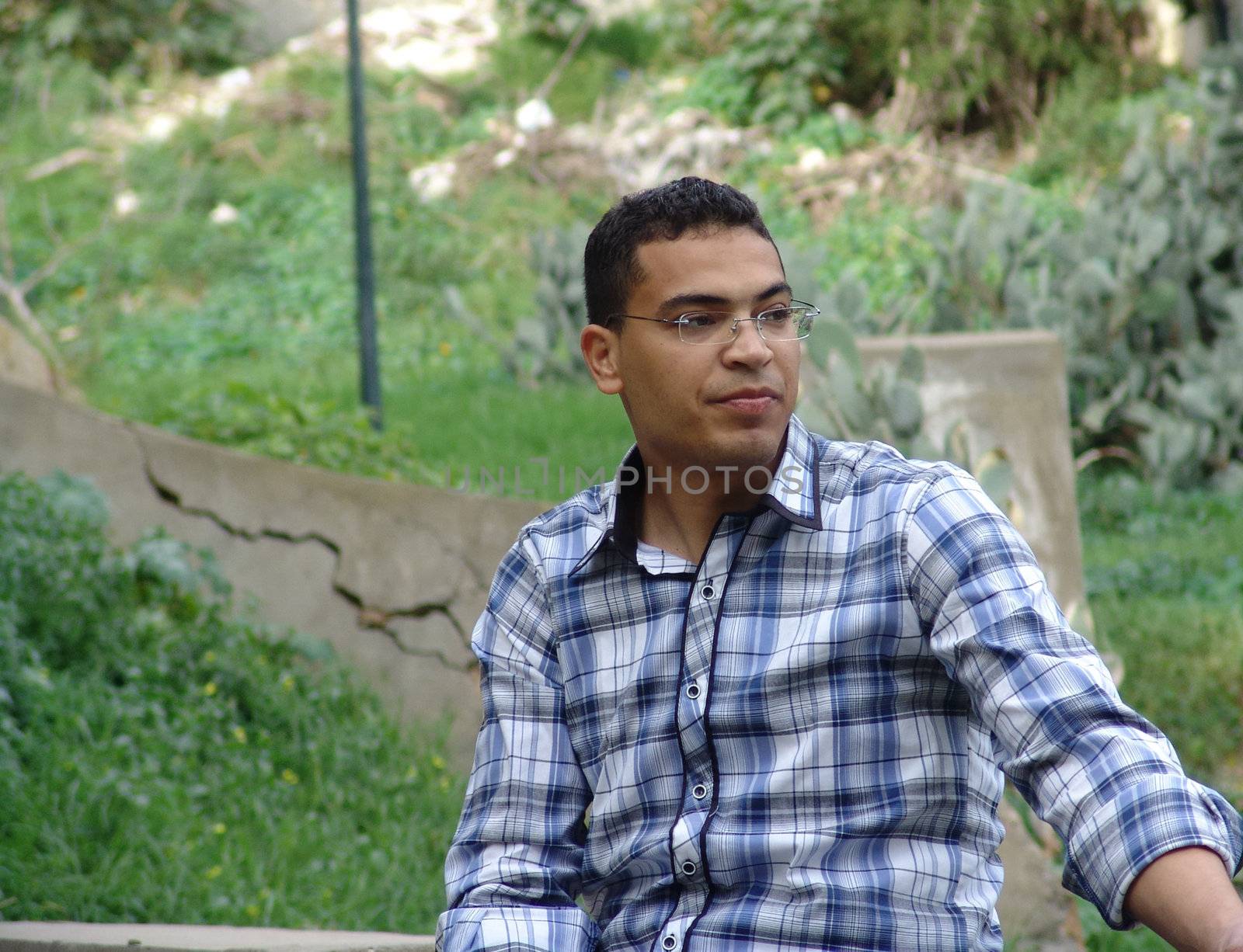 Tunisian man sitting in the tunisian forest.