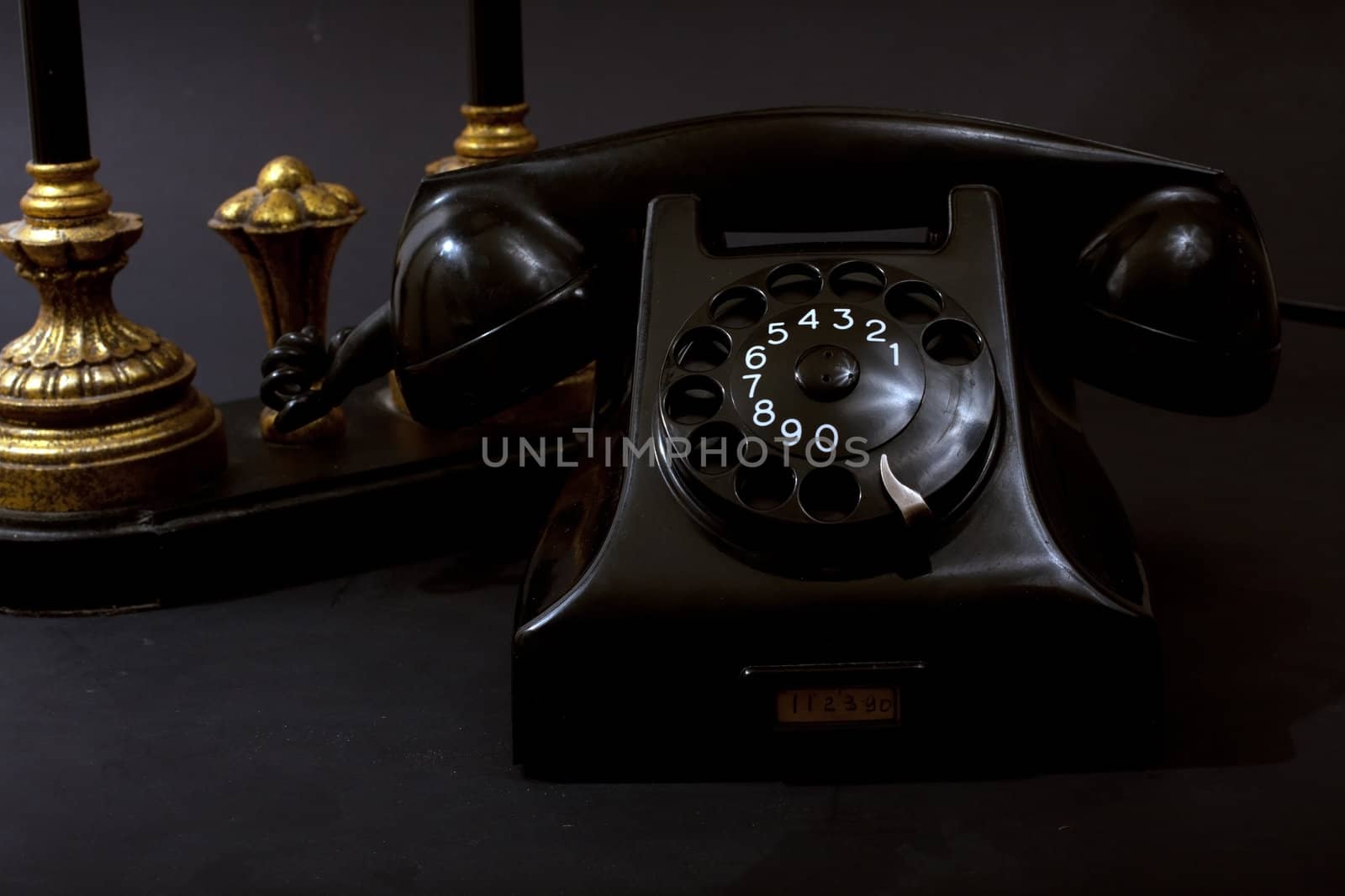 Antique Telephone with lamp on black background