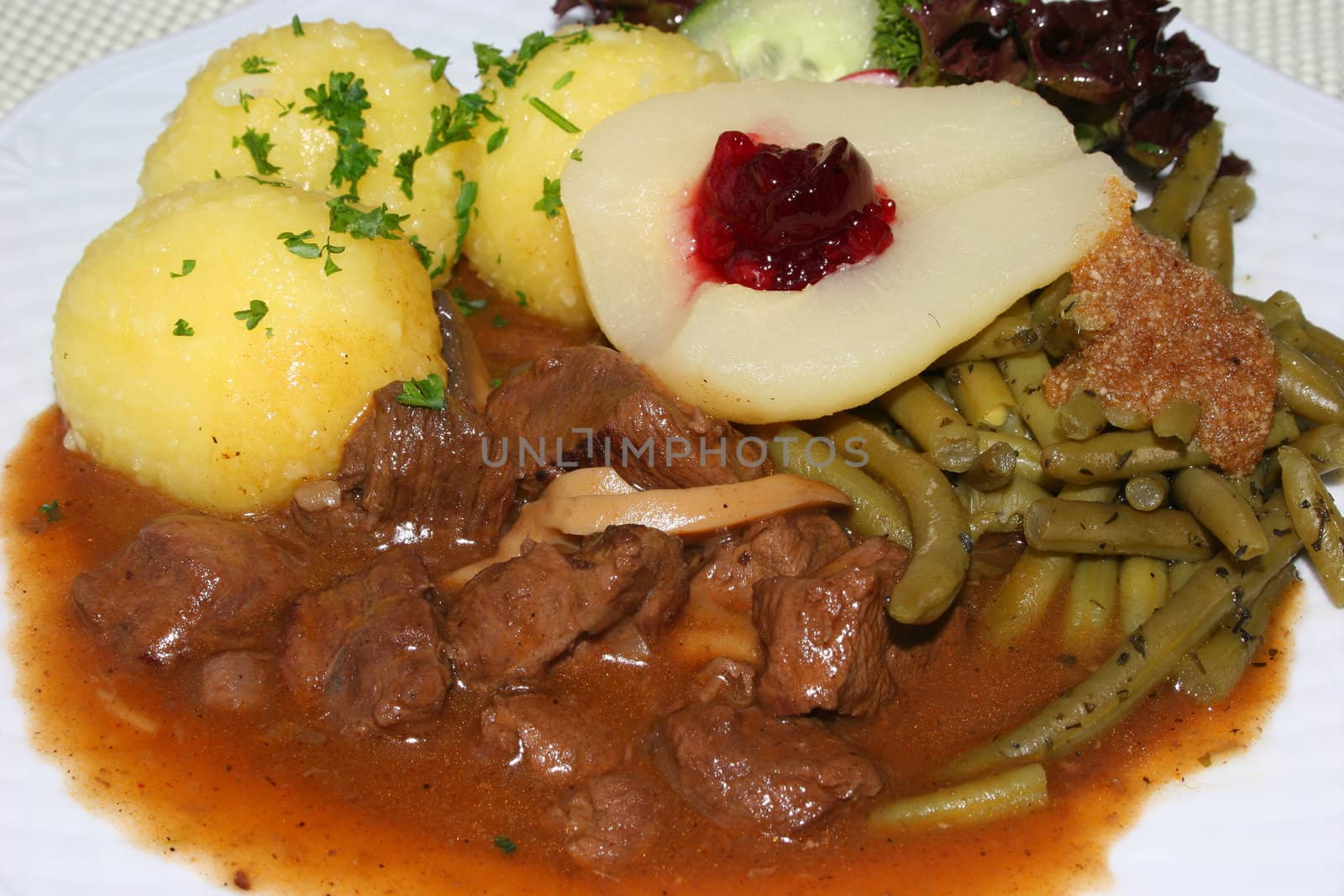 Venison goulash with potato  dumplings and garnish