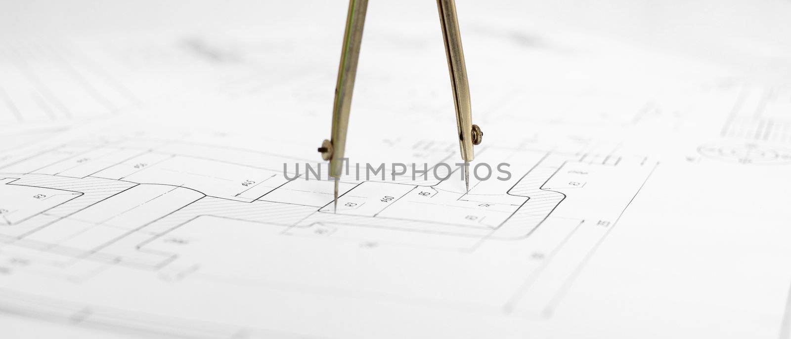 Metal compasses against engineering drawing by pzaxe