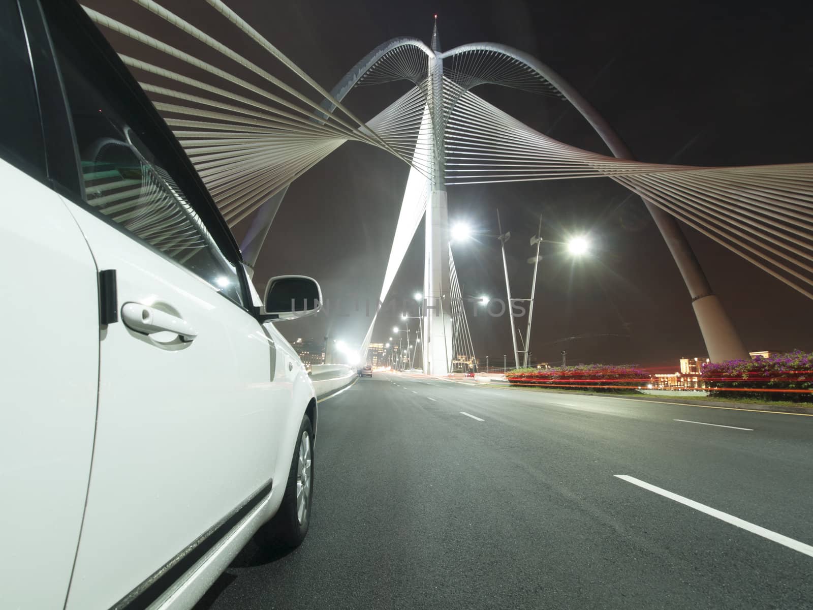 White car on the modern Seri Wawasan Bridge in Putrajaya Malaysia