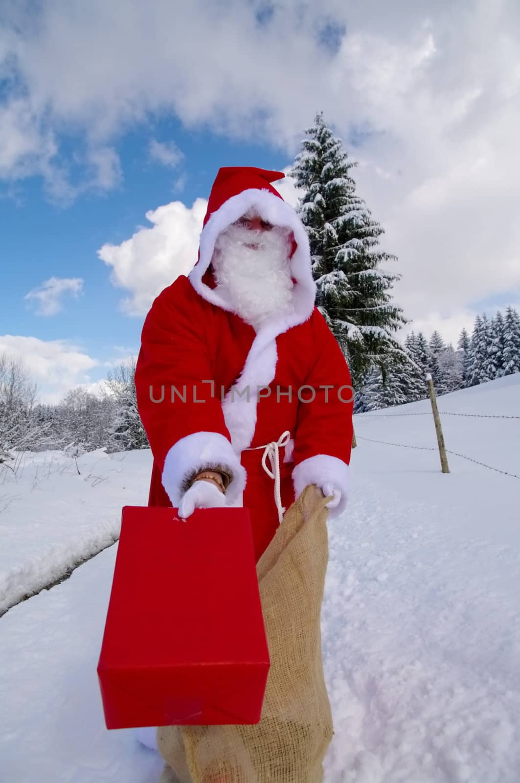 Santa Claus, Father Christmas holds red present