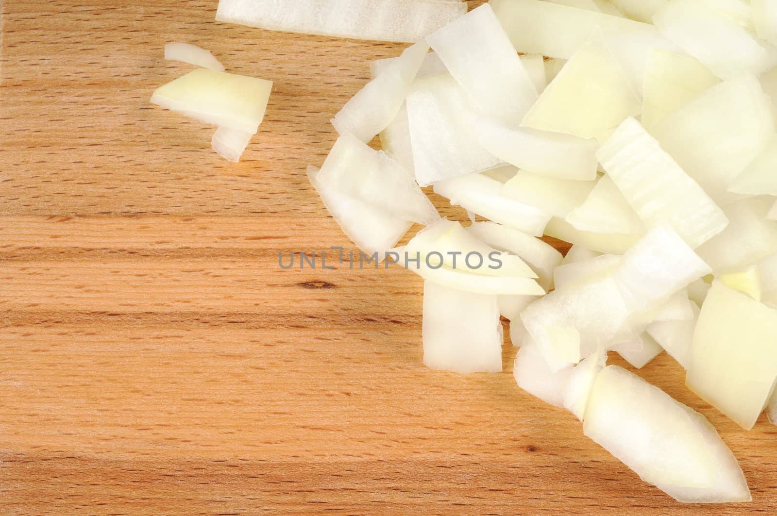 Chopped onions on a wooden board. CloseUp.