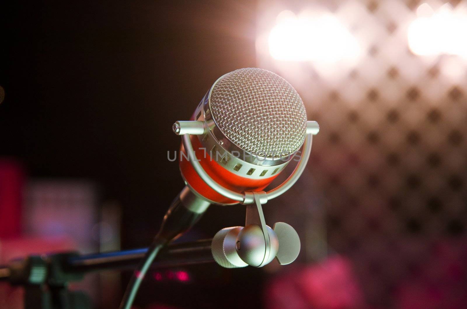 Closeup of audio microphone on stage background