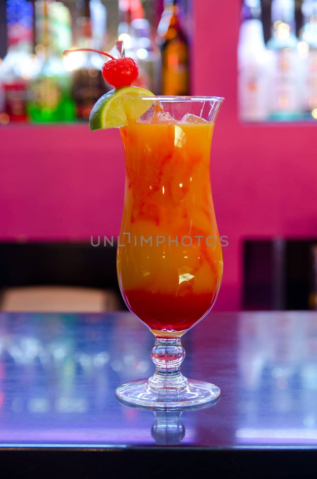 Tropical cocktail in glass on bar counter