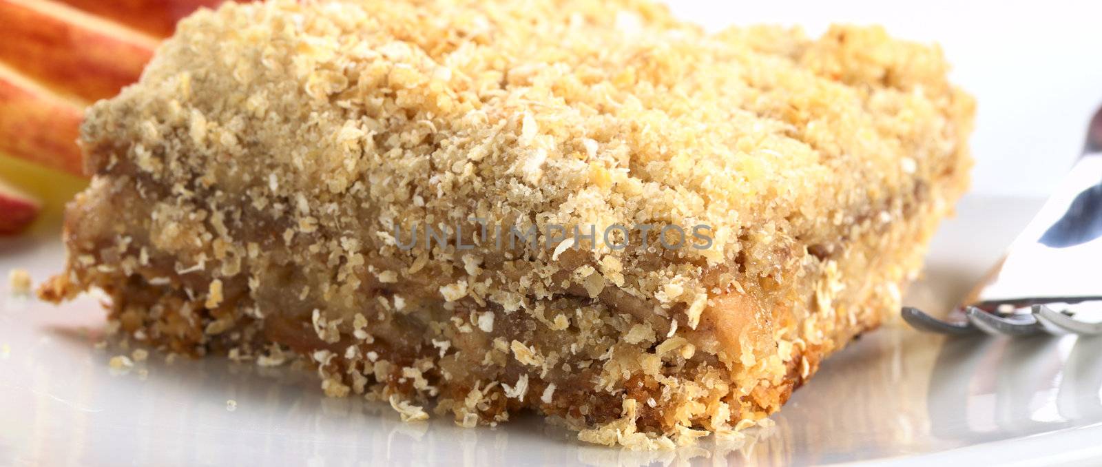 Apple crisp made of oatmeal and apple, mixed with cinnamon and brown sugar (Selective Focus, Focus on the front corner)