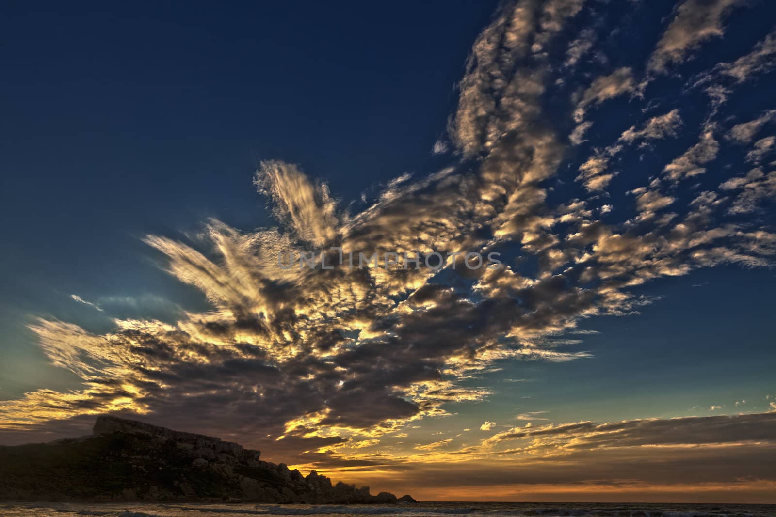 Beautiful cloud cover during dusk at Ghajn Tuffieha Bay in Malta