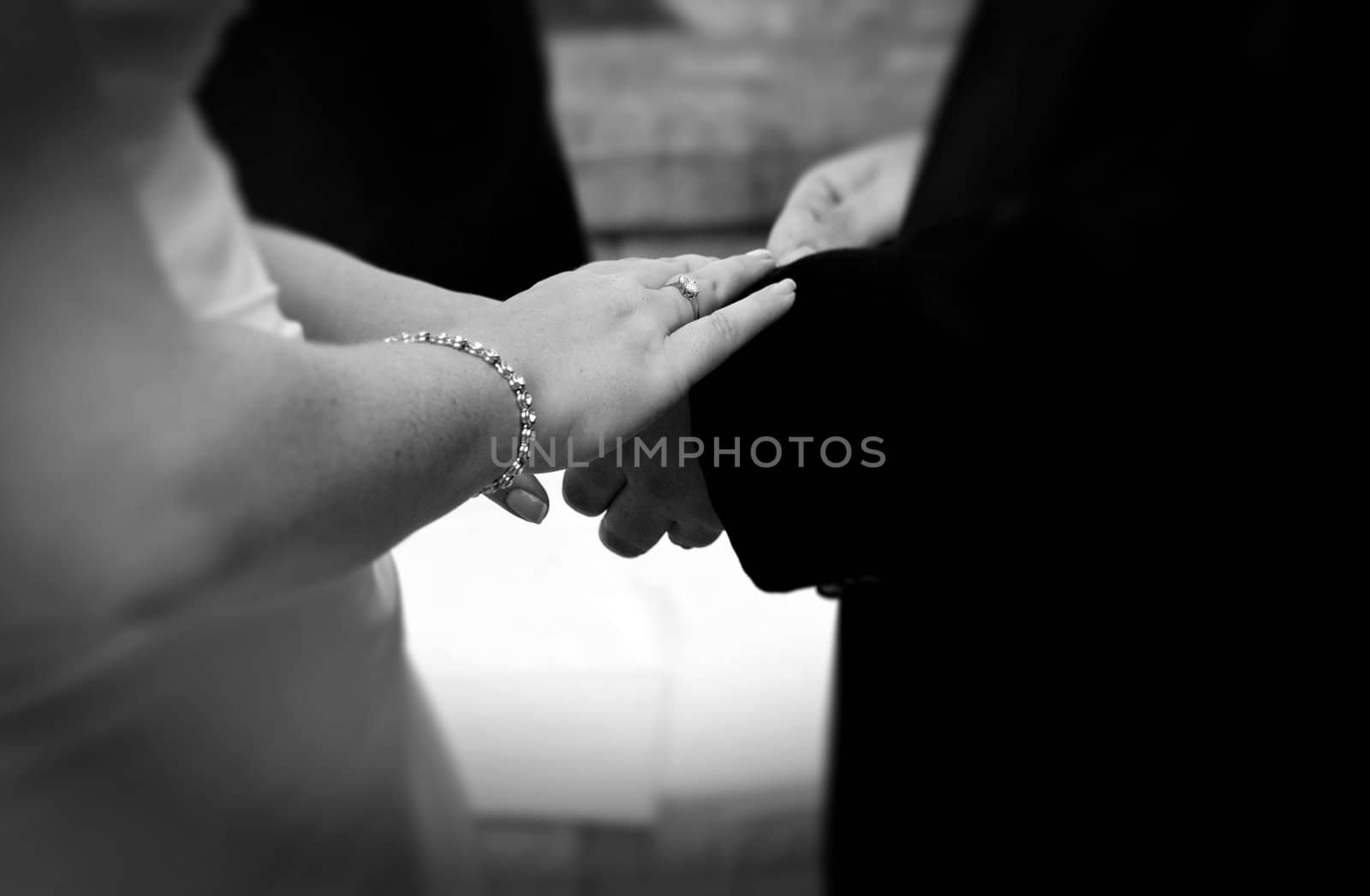 Detail of bride and groom's hands showing wedding bands