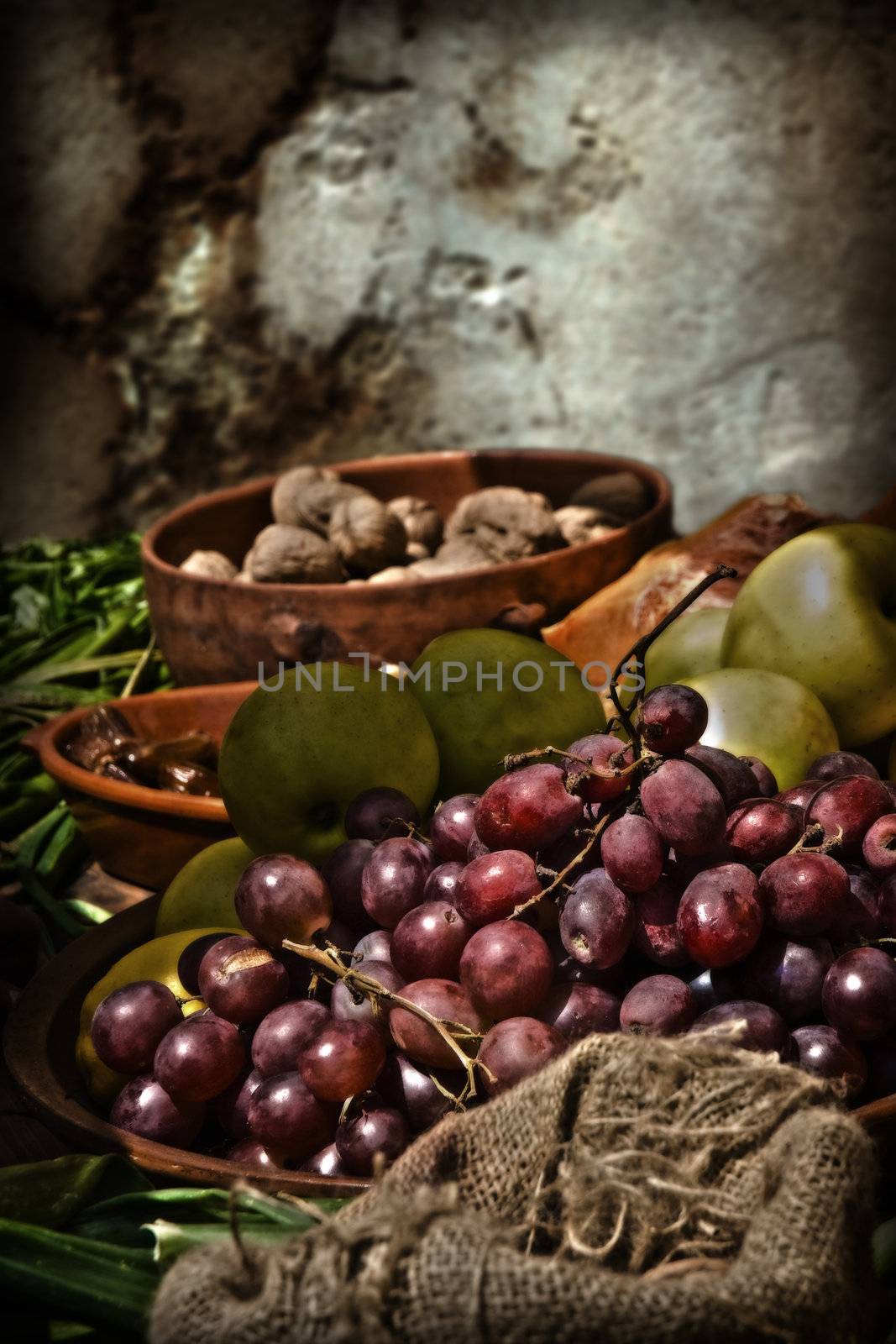 Mediterranean grapes and apples and other veg still life