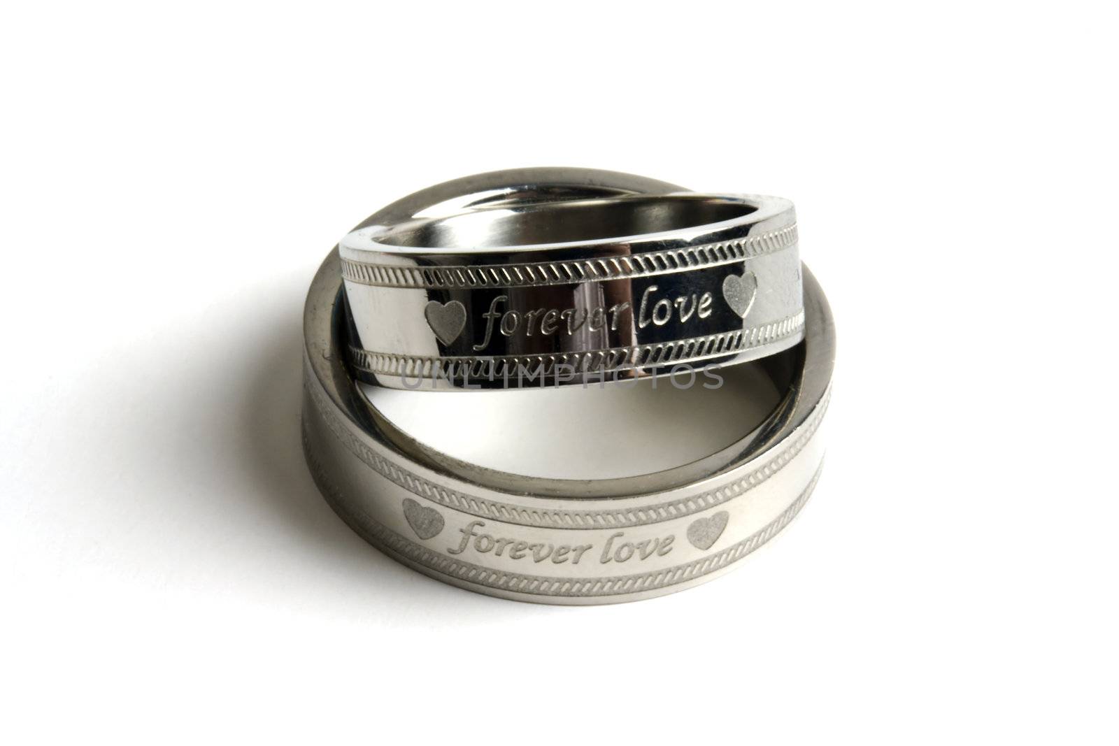 Wedding rings of Forever Love isolated on white
