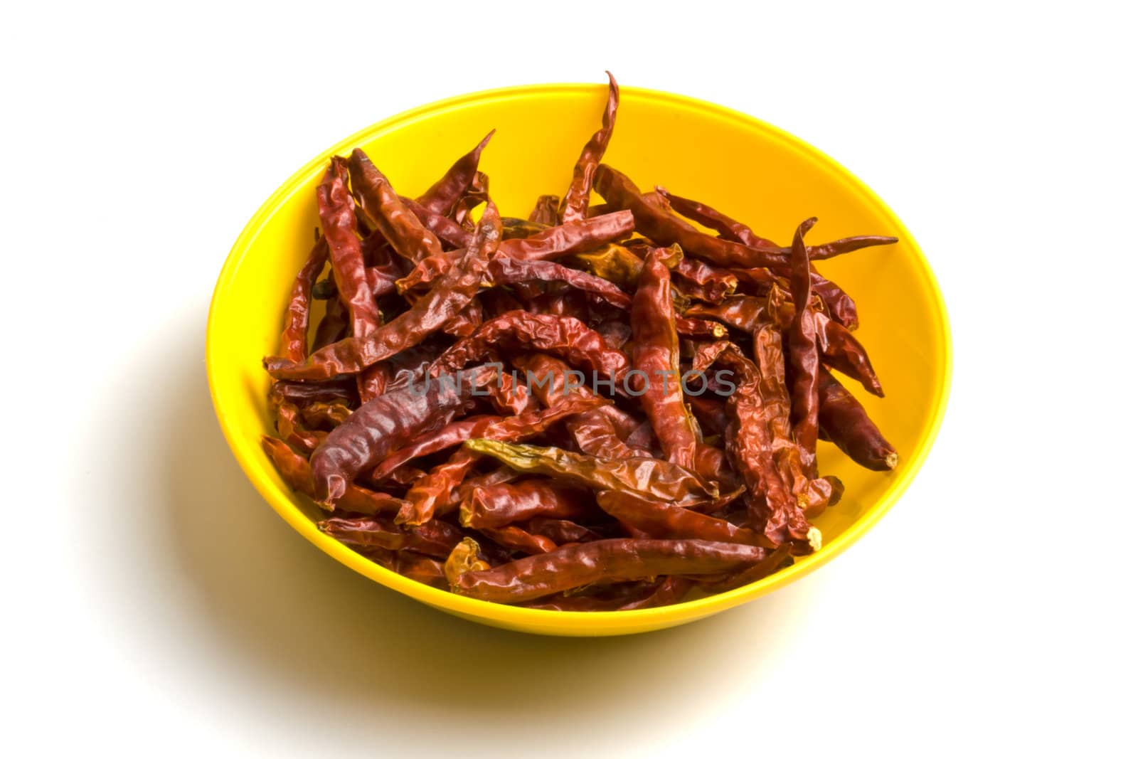 Plate of dried red chilli isolated on white