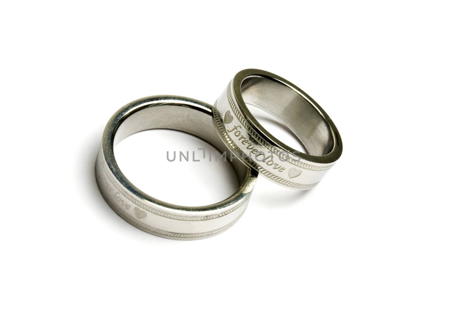 Wedding rings of Forever Love isolated on white 
