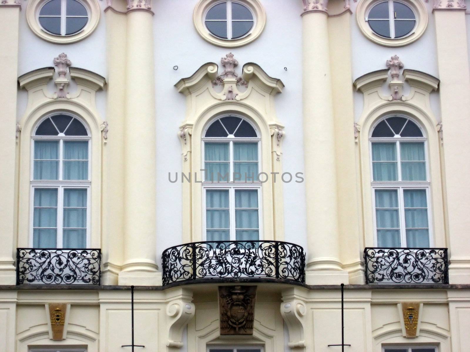 Classic windows with statues and balconies in Prague 
