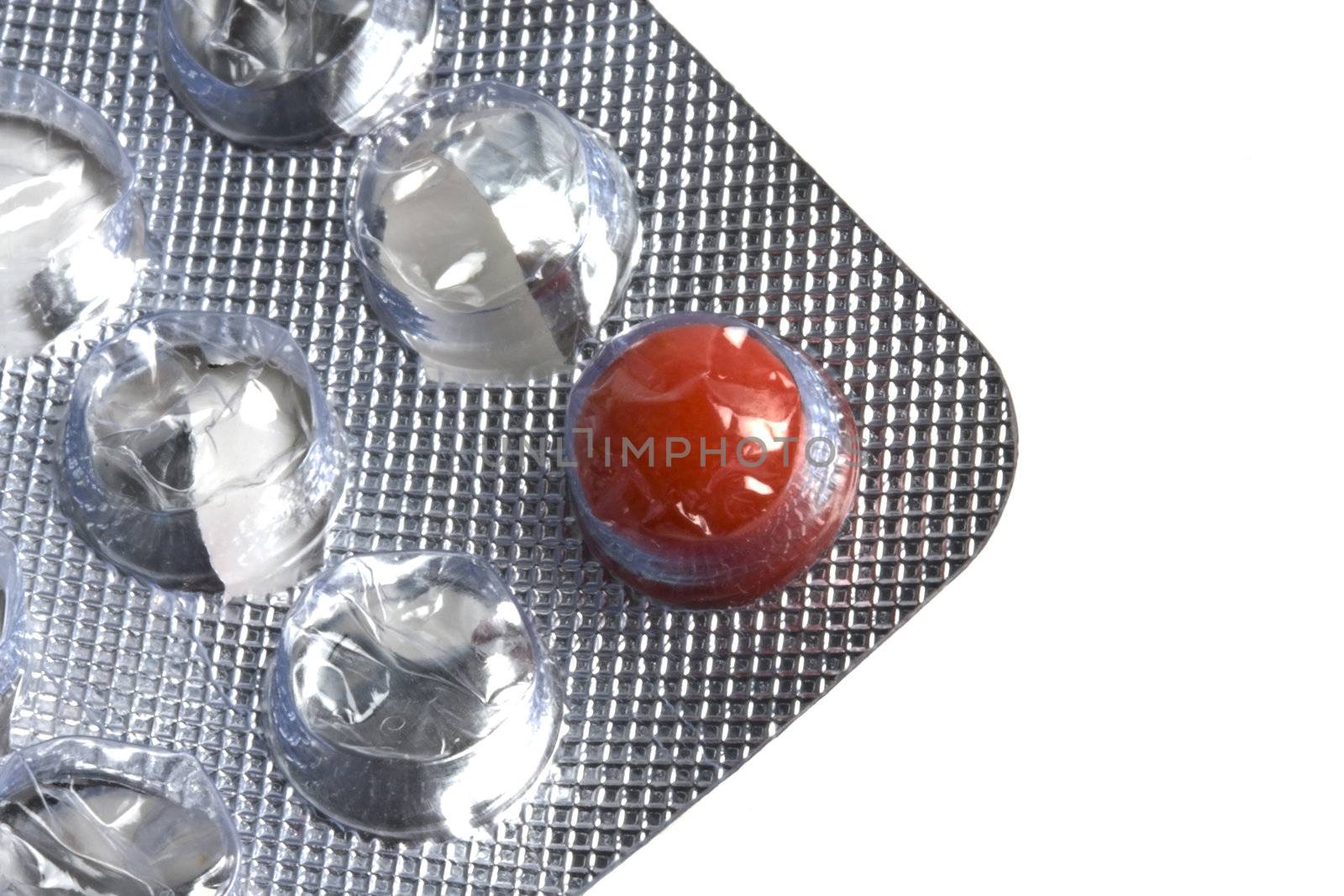 One red pill isolated on white background