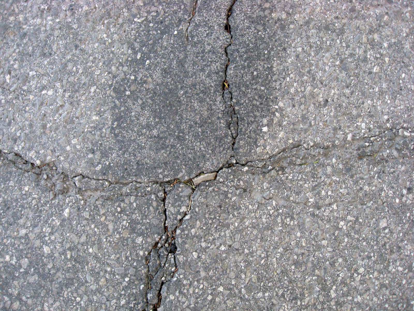 Texture of cracks on asphalt background 