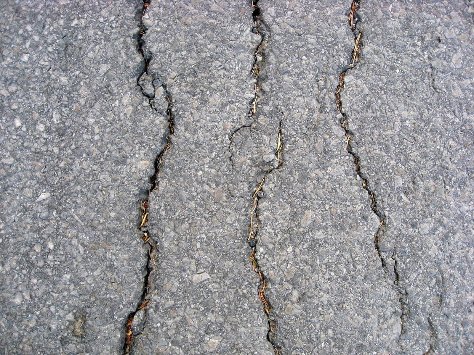 Texture of cracks on asphalt background 
