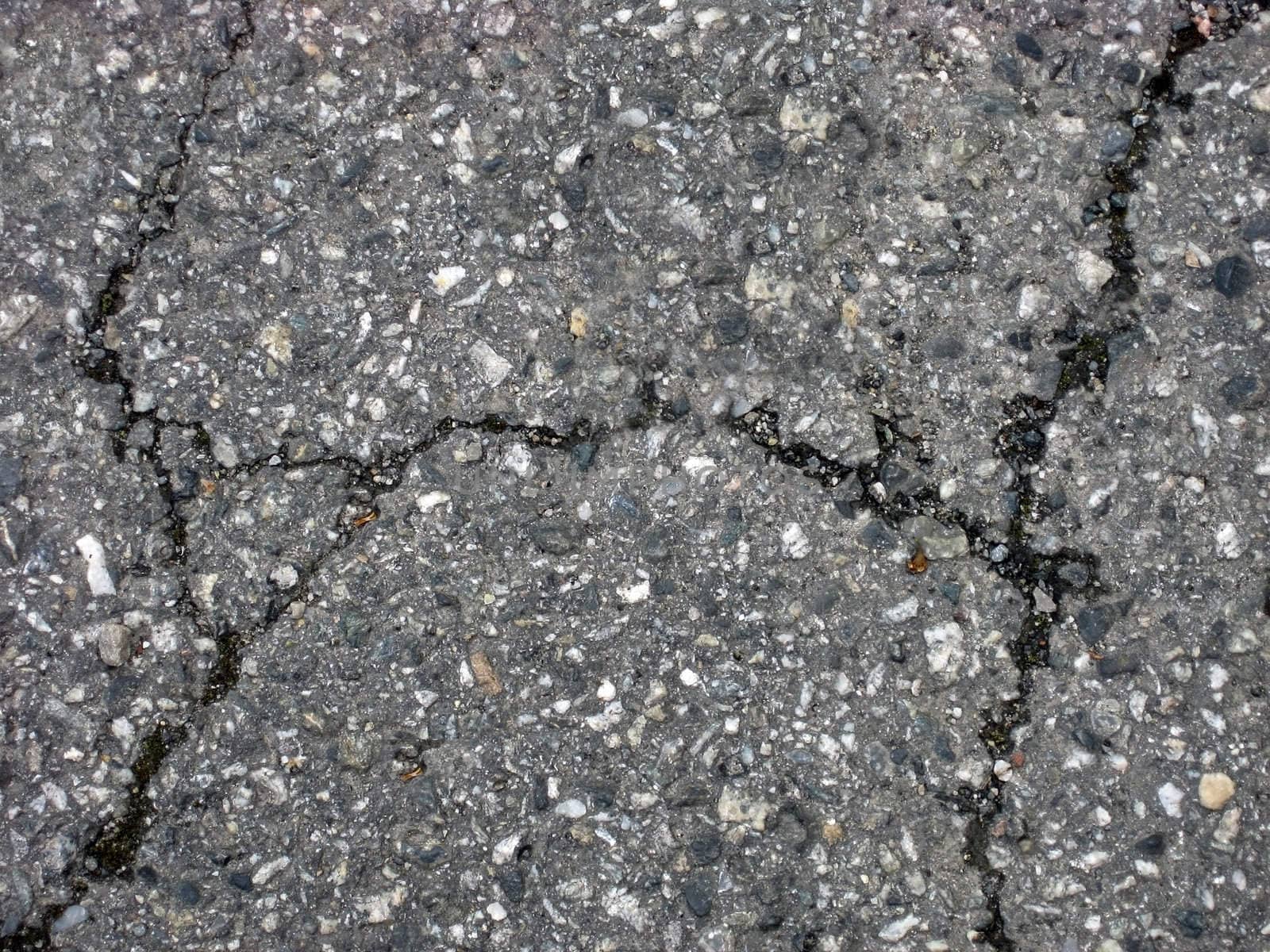 Cracks on asphalt background 

