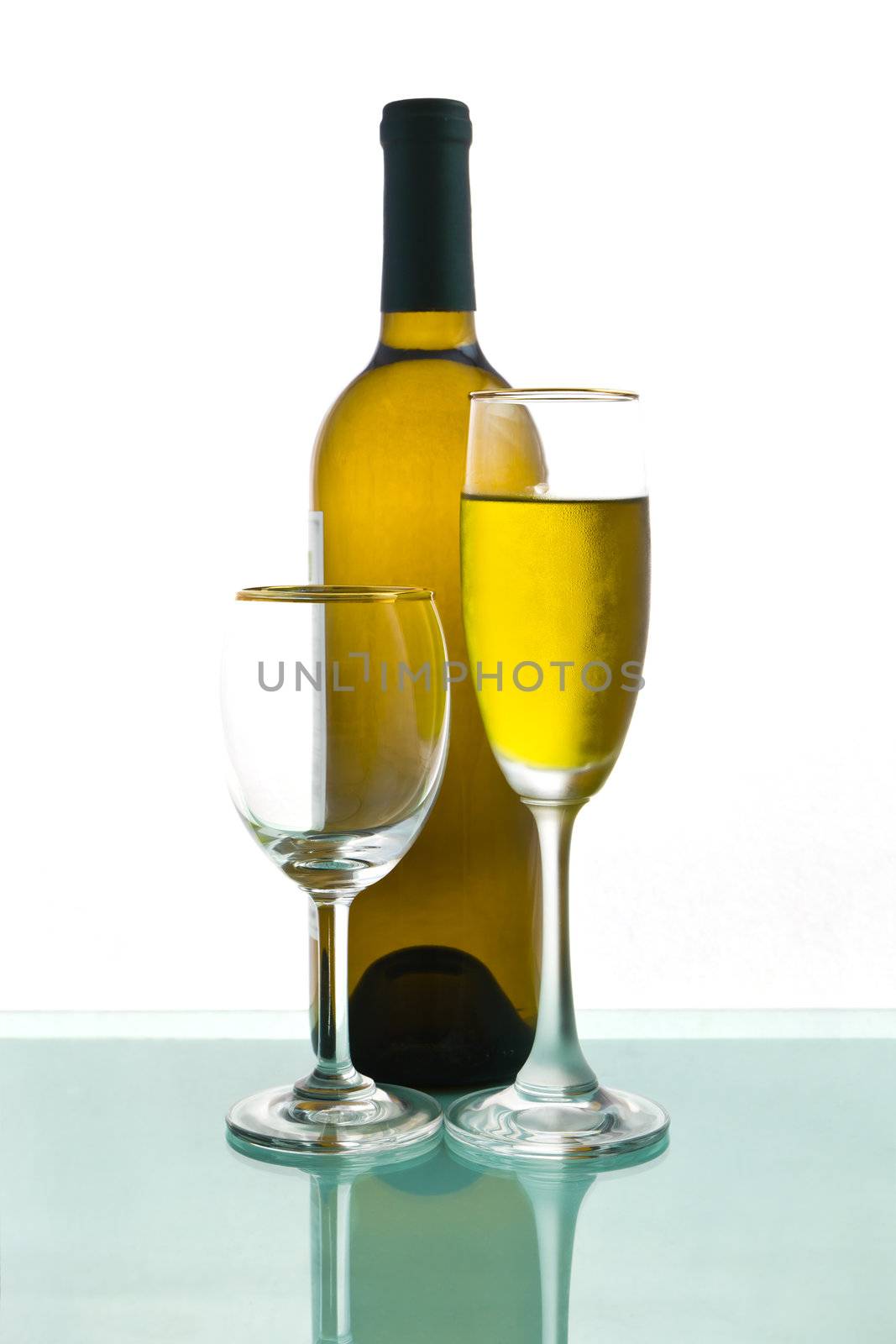 Bottles and glasses of wine on background