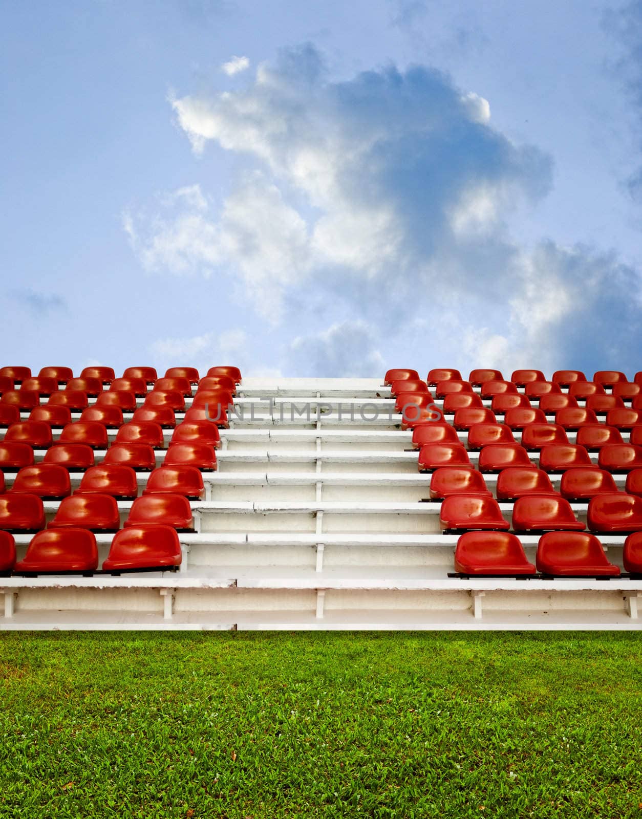 Red granstand in arena with blue sky by pixbox77