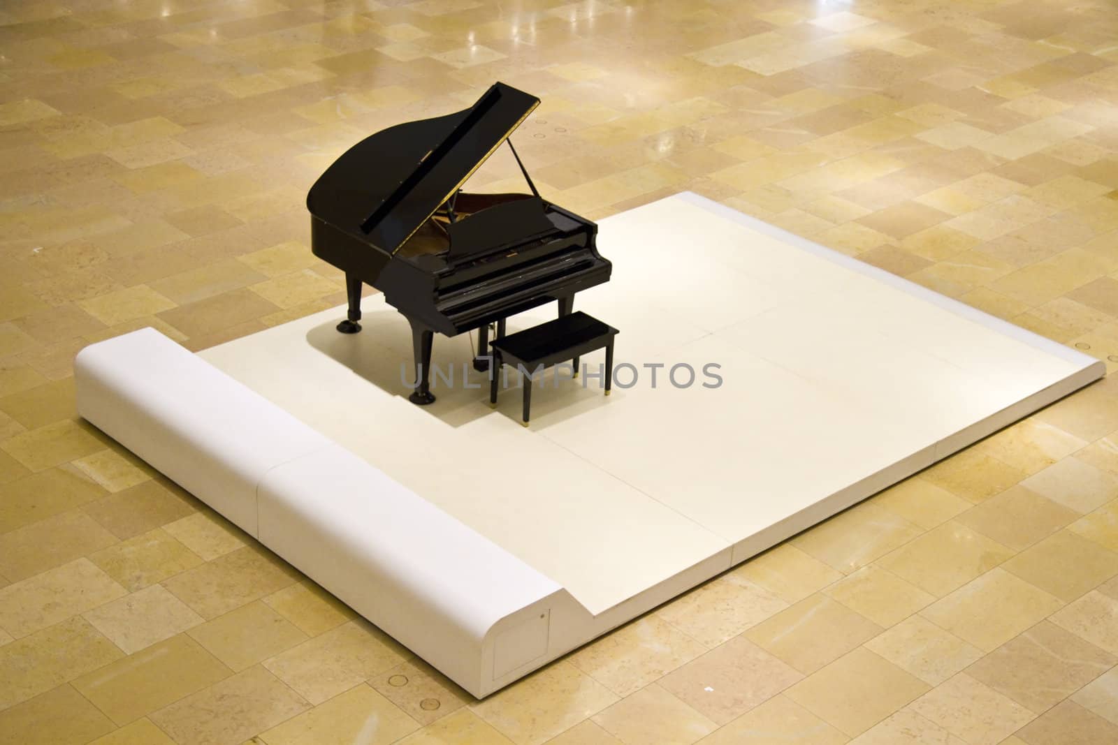 Grand Piano on white in a shopping mall lobby