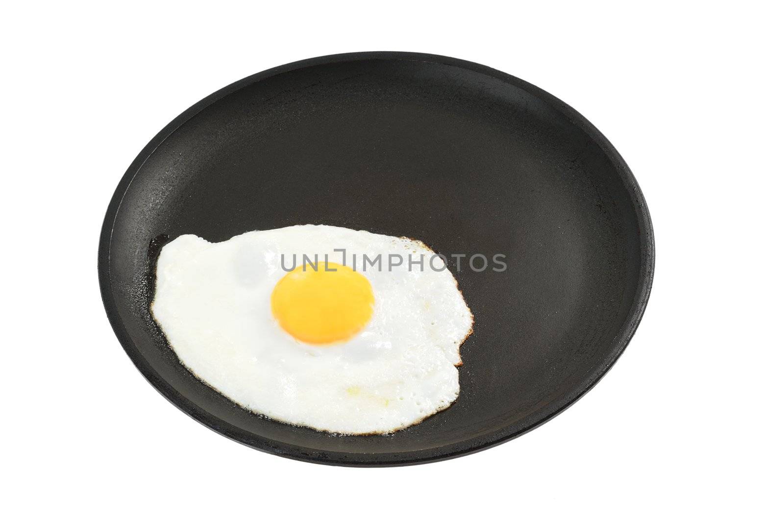 Fried eggs on a frying pan. Isolated on white.