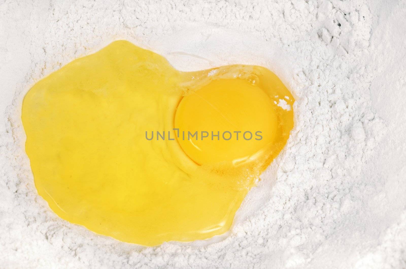 Broken eggs  in the flour. Close up