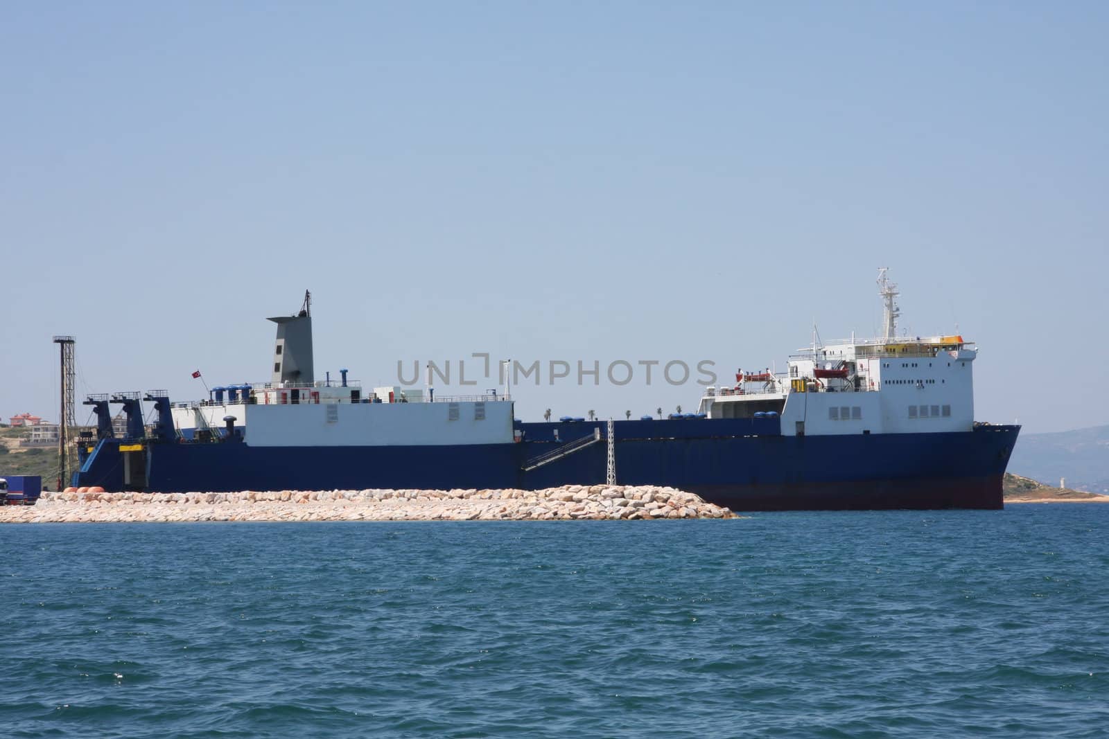 Cargo Ship loading and unloading in the harbour at Cesme, Turkey