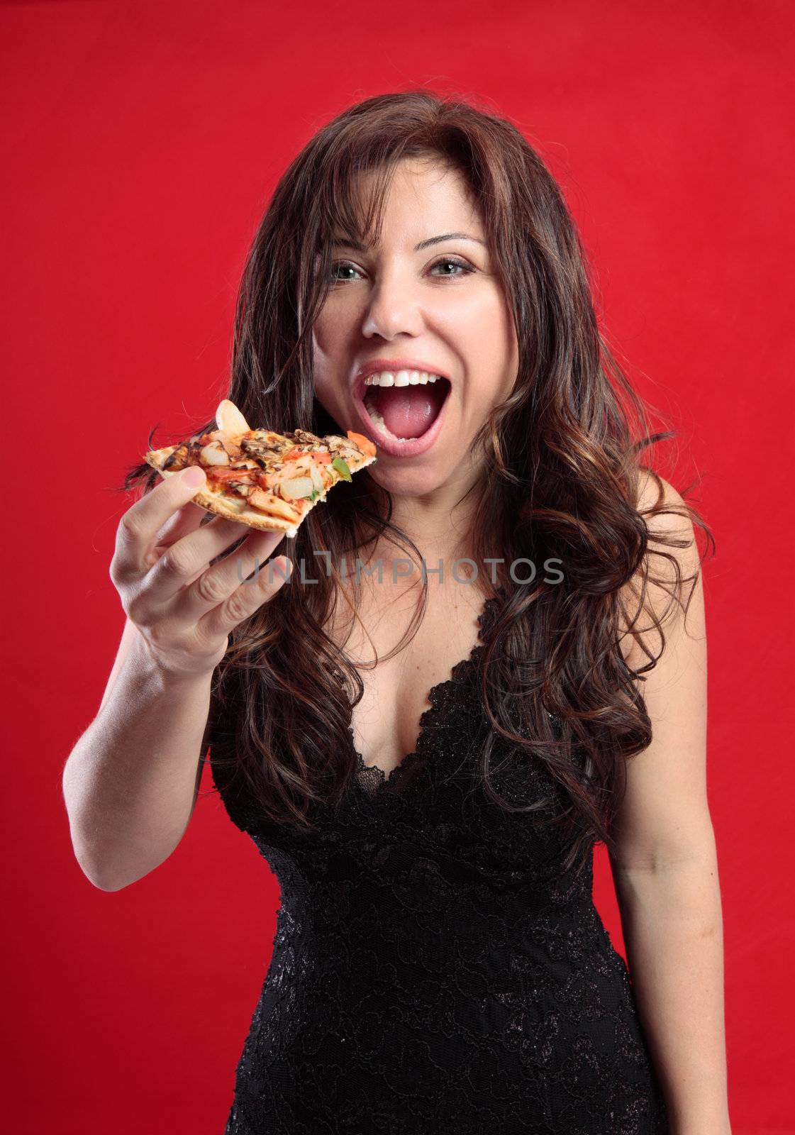 Sexy female eating a slice of delicious pizza