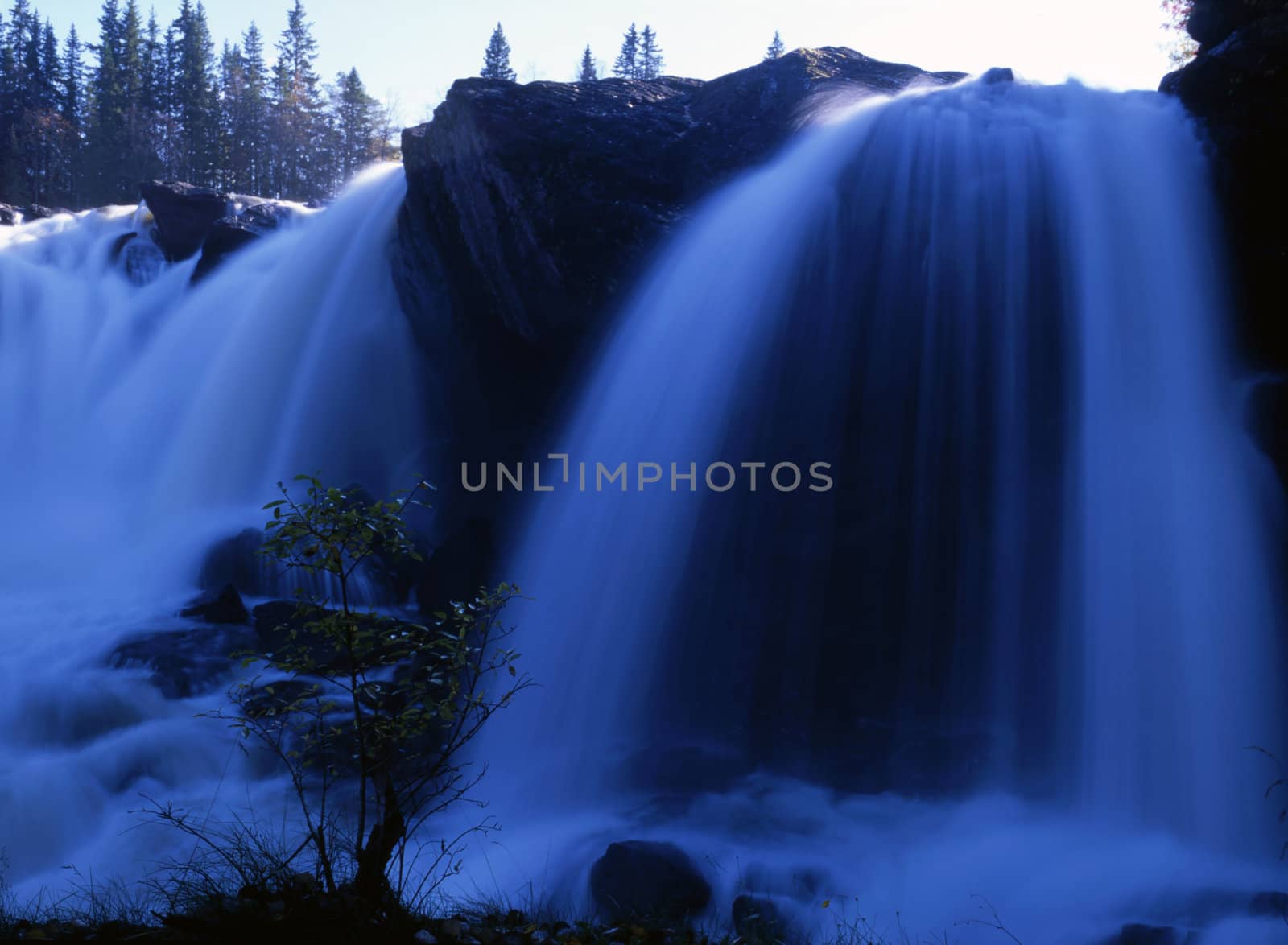 Flowing water of beautiful waterfall closeup