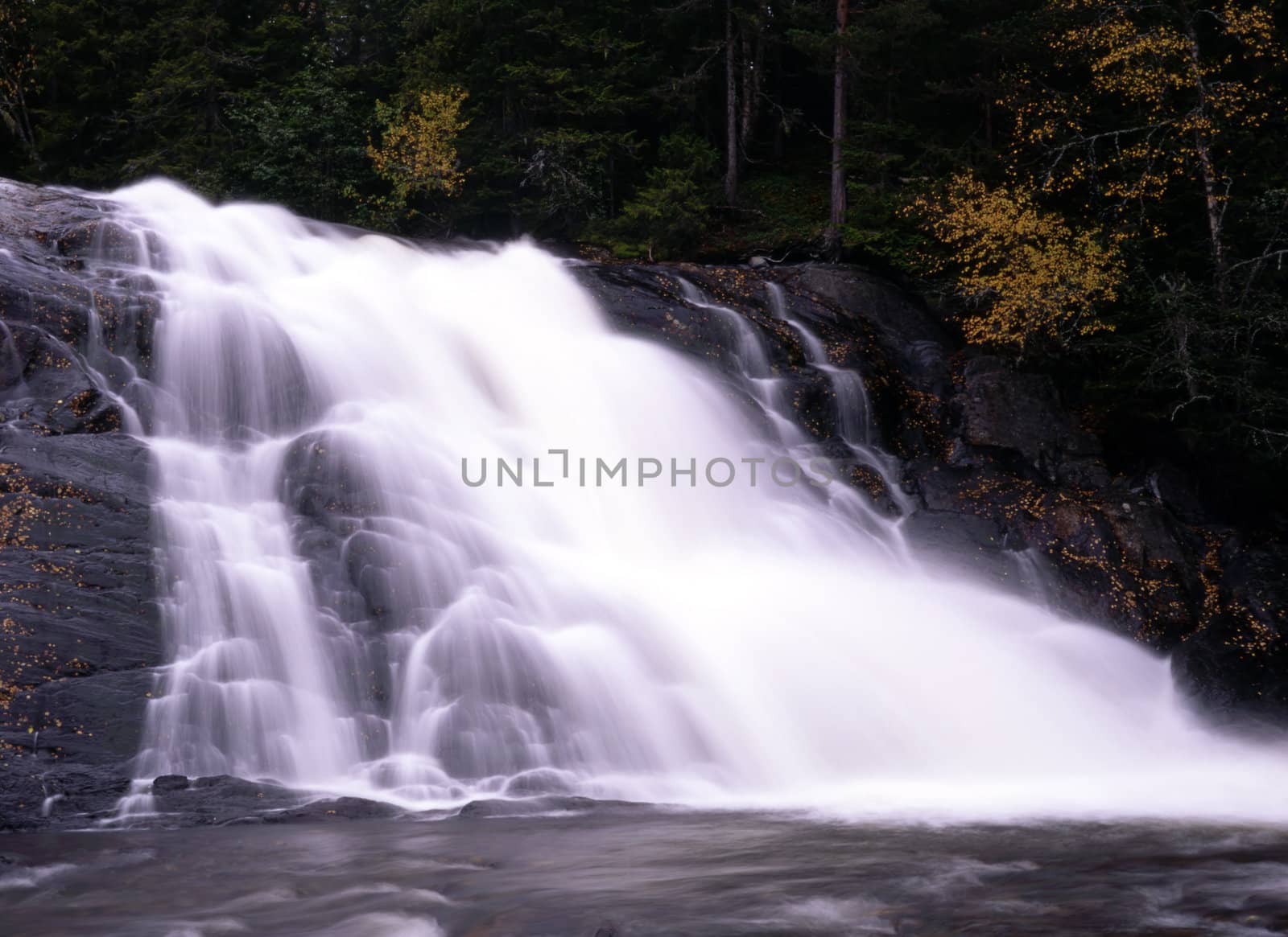 Flowing water from mountain waterfall 
