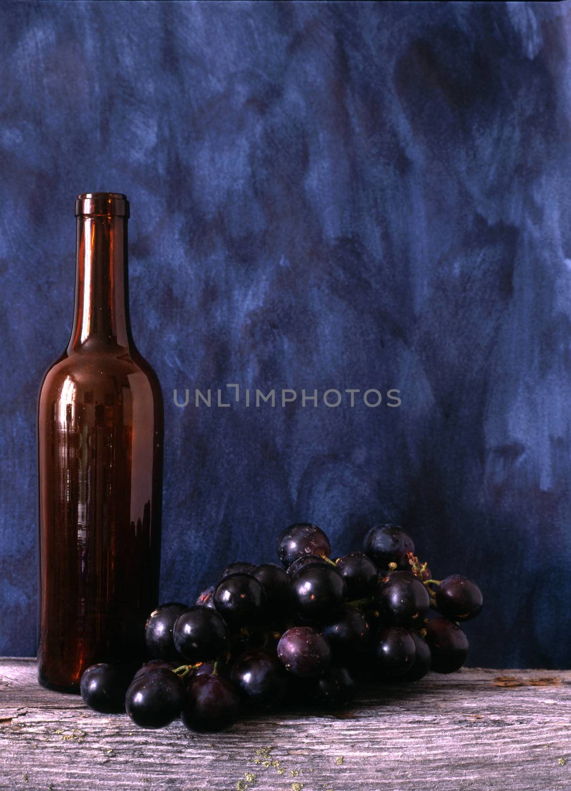 wine bottle and grapes by ibphoto