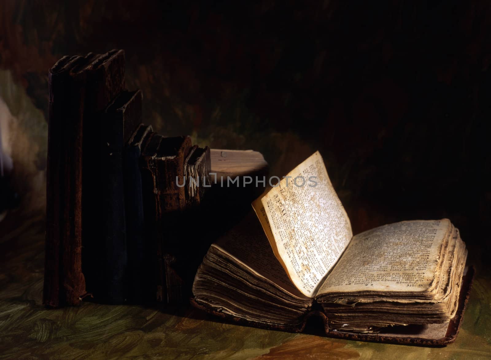 Stack of old books isolated on painted background 